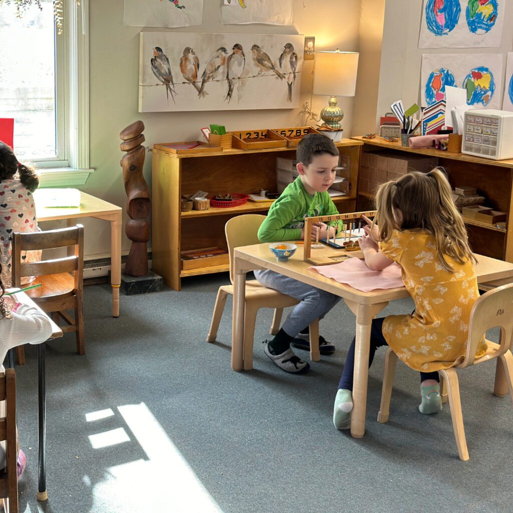 Kindergarten students working together as part of their morning work cycle.